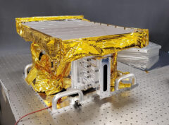 The side of the High-resolution Volatiles and Minerals Moon Mapper (HVM3) is seen as the instrument gets unwrapped in a clean room. The JPL-developed imaging spectrometer was later integrated with NASA’s Lunar Trailblazer spacecraft. (Lockheed Martin Space)