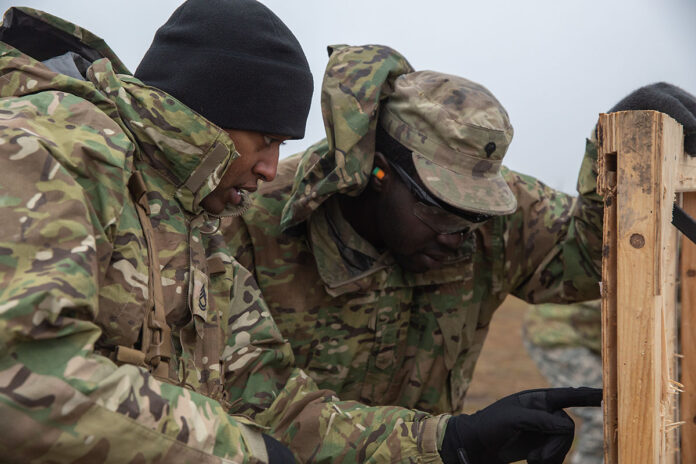 A U.S. Army instructor for the ‘Team Leaders Course’ of 1st Battalion, 502nd Infantry Regiment, 2nd Brigade Combat Team, 101st Airborne Division (Air Assault), instructs a junior Soldier on how to adjust a sight pitch based off of shot groupings on a paper target, on a range in Constanta Romania during a ‘Team Leaders Course’, Jan. 12, 2023. Soldiers underwent a week of training designed to reinforce the standard of junior leaders in leadership positions. Classes taught by leadership followed by the hands-on training exercises are how these Soldiers of the 1-502 instill the standards of being leaders. (Sgt. Nicholas Goodman, 101st Airborne Division)