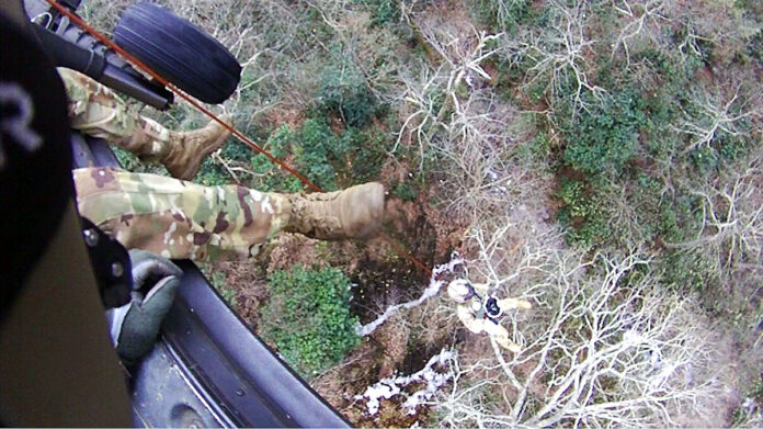 Staff Sgt. Ryan McKnight lowers Staff Sgt. John Sharbel during a recovery mission on the Appalachian Trail, Dec. 31, 2022. Local authorities requested help from the Tennessee Emergency Management Agency and the Tennessee National Guard to rescue two stranded hikers the morning of New Year’s Eve. The two hikers were airlifted to Johnson City Medical Center where they recovered from minor injuries before being released. (Submitted photo)