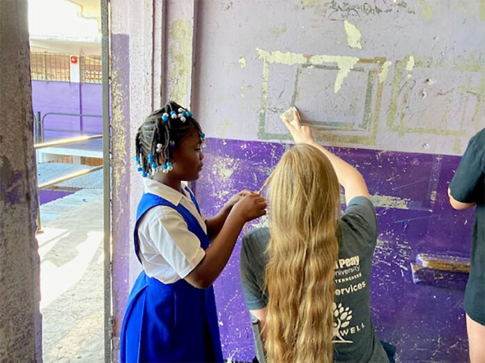 China braids Megan Schneck's hair. (APSU)