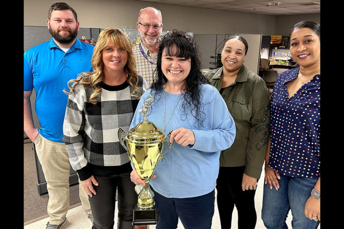 When Blanchfield Army Community Hospital Chief of Civilian HR, Sherry Cox (center) was named the hospital’s Civilian Employee of the Year, she shared the recognition with her team, (from left) Keith Chumley, Tami McChesney, Mark Schluckebier, Atavea Quarles, and Marcy Wilks (not shown Julie Clemmons and Joybelle Cacacho). The team made history transitioning more than 1,300 pay and personnel records of current BACH civilian employees from Department of the Army to Department of Defense as part of the hospital's administrative transfer to the Defense Health Agency. Cox will represent BACH at Fort Campbell Kentucky’s 65th Annual Civilian Employee of the Year Awards Ceremony, 1st Line Supervisor Category, April 27th. (Maria Christina Yager, Blanchfield Army Community Hospital)