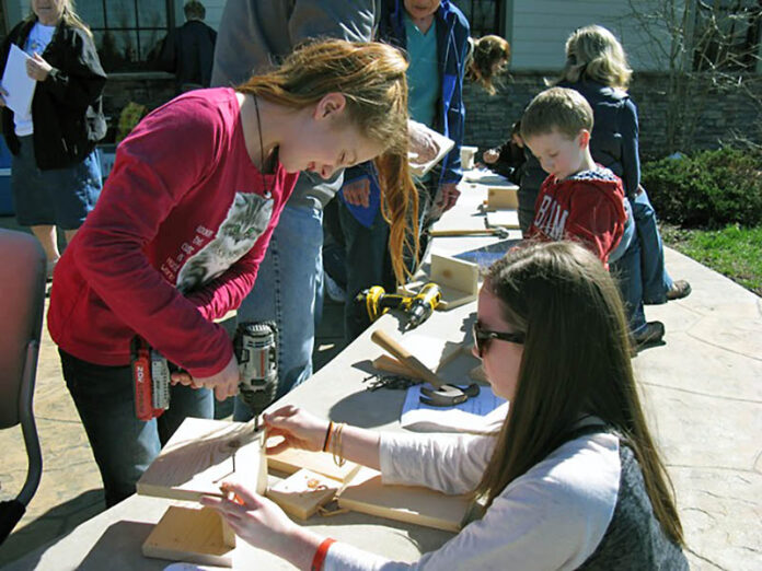 Sisters Courtney and Abby Colley build a bluebird box at the refuge bluebird program held in 2018.