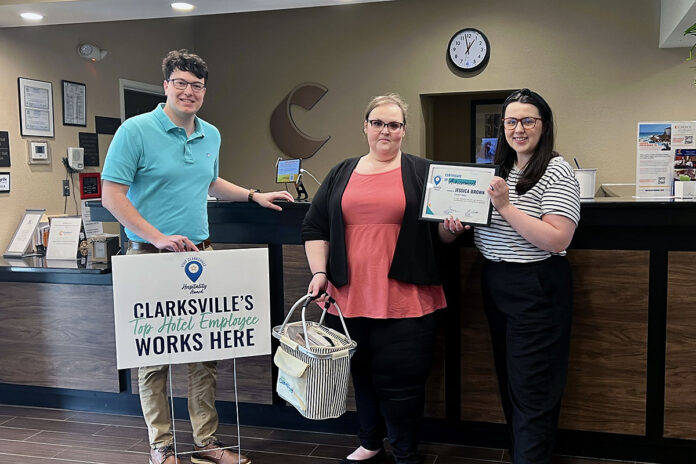 Jessica Brown proudly stands with Blake Monroe and Amanda Wall after receiving her award.