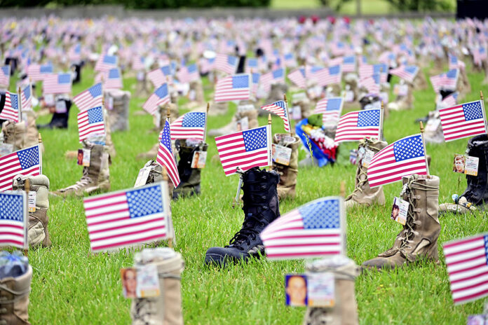 Gold Star and surviving families, Soldiers and veterans gather to pay tribute to fallen service members during the 9th annual Boots on the Ground Display Ceremony, May 19th, at the 101st Airborne Division (Air Assault) Headquarters. Hosted by the 101st Airborne Division and Fort Campbell Army Community Service Survivor Outreach Services, the boots represent service members who have died since September 11th, 2001, both on and off the battlefield. The visual reflection of the enormity of loss included 7,890 boots. (Kayla Cosby, Fort Campbell)