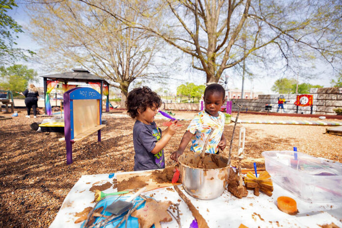 Children enjoy a mud painting activity at Austin Peay State University's Little Govs CLC's outdoor play space. (APSU)