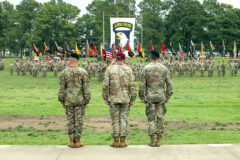 Lt. Gen. Christopher Donahue, commander of XVIII Airborne Corps, Maj. Gen. JP McGee, outgoing commander of the 101st Airborne Division (Air Assault), and Maj. Gen. Brett Sylvia, incoming commander, watch the division colors come together during the division Change of Command ceremony at Fort Campbell, Ky., July 20, 2023. The change of command ceremony is a tradition where the outgoing commander symbolically relinquishes command and authority by passing the division’s colors to the presiding officer, who then hands the colors to the incoming commander, thus beginning a new era of leadership for the incoming commander and the division as a whole. (Sgt. Andrea Notter, 101st Airborne Division)