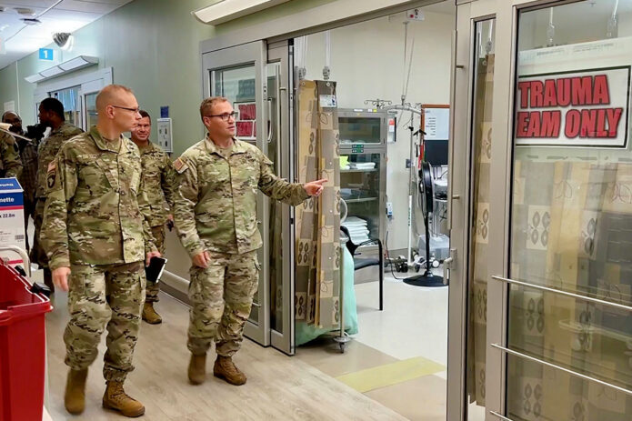 Blanchfield Army Community Hospital Emergency Medicine Physician Maj. Josef Jessop (right) leads 101st Airborne Division (Air Assault) and Fort Campbell Commanding General Maj. Gen. Brett G. Sylvia (left) and the division’s Command Sgt. Maj. Charles D. Walker on a tour through the hospital’s Emergency Center, August 29th. The hospital’s EC is staffed 24/7 by military and civilian healthcare providers.