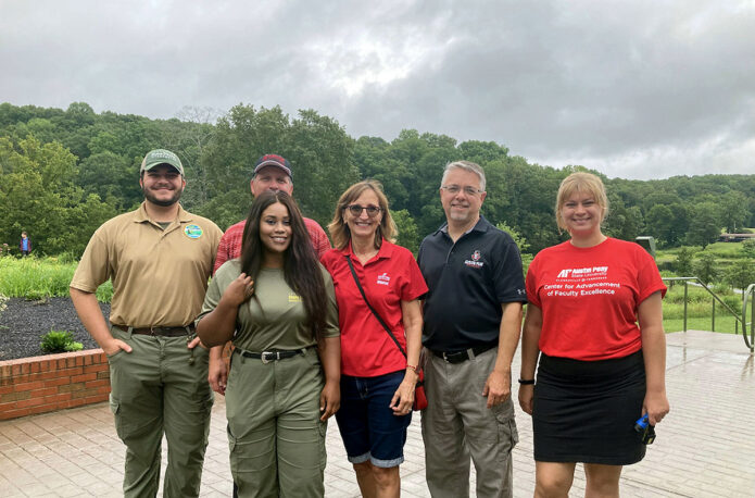 Austin Peay State University graduate history student Ifunanya Ejimofor leads a tour group of APSU employees through Dunbar Cave State Park. (APSU)