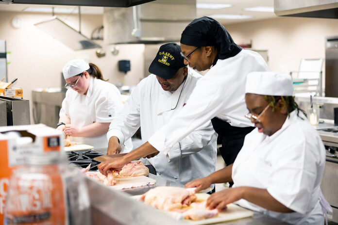 Chef Carl Conway, the director of Austin Peay State University's culinary arts program, shows students how to fabricate a chicken. (APSU)
