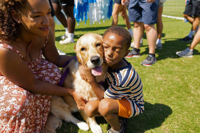 Xavier, a Make-A-Wish child and cancer survivor, with his dog Journey. (APSU)
