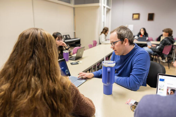 Dr. Zack Barnes, an assistant professor of education at Austin Peay State University, works with honors students in “Is the Education System Broken?” (APSU)