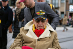 WWII veteran Gerald White joins soldiers of the 101st Airborne Division (Air Assault) as they march with other WWII veterans, a local band, members of the Belgian military, Soldiers from Benelux, Belgian school children, and members of the community during a parade to celebrate the 79th anniversary of the Battle of the Bulge, in Bastogne, Belgium Dec. 16, 2023. (Staff Sgt. Joshua Joyner, 101st Airborne Division (Air Assault)