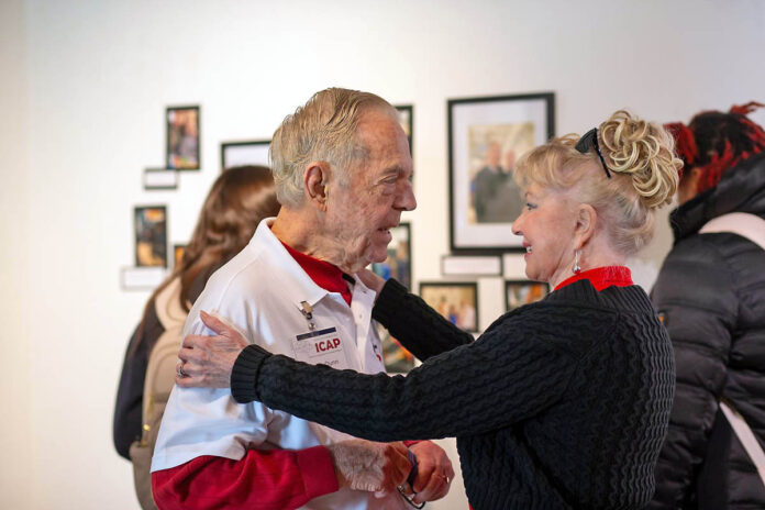 Jim Dunn and his wife, Pat, share an embrace during the CCC-ICAP’s closing photo exhibition. Dunn, a retired businessman, incorporated several family photos into his display. (Jaylon Gonzales, APSU Student)