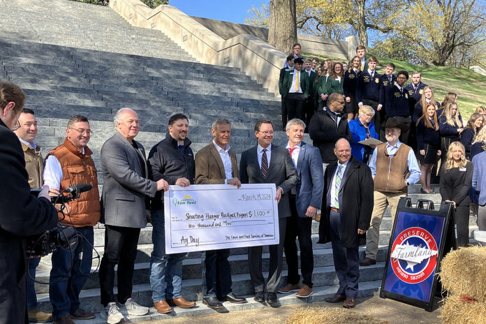 Tennessee Governor Bill Lee, Agriculture Commissioner Charlie Hatcher, DVM, Tennessee State lawmakers, and the Farm and Forest Families of Tennessee organization presenting a check to the Shooting Hunger Backpack program.