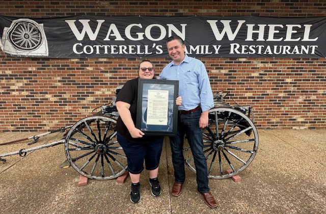 Cheryl Cotterell holds the proclamation from the County Mayor along with Montgomery County Mayor Wes Golden outside the former restaurant.