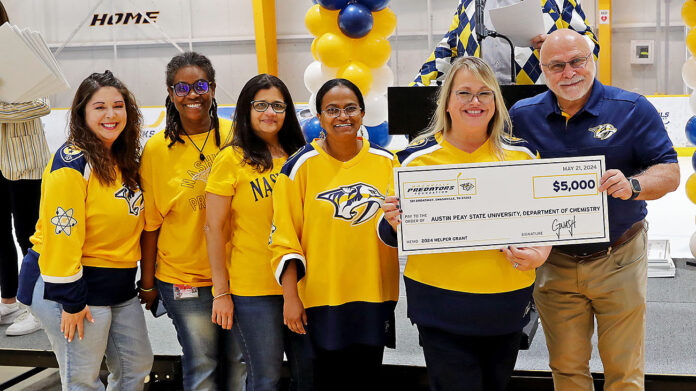 Austin Peay State University faculty and staff members accept a $5,000 check from the Nashville Predators Foundation during the organization’s annual Helper Grant Check Presentation Ceremony. (APSU)