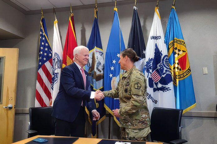 Dr. Michael Jordan, Vice President of Service to the Armed Forces and International Services at the American Red Cross, shakes hands with Colonel Megan B. Stallings, Commander, U.S. Military Entrance Processing Command, after signing the historic MOU to that aims to give the Red Cross Emergency Communications brief to 100% of military recruits.