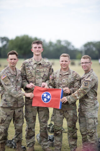 Four Soldiers from Ashland City’s Troop B, 1st Squadron, 278th Armored Cavalry Regiment, won first place during the prestigious 2024 Sullivan Cup competition at Fort Moore, Georgia, from April 29th to May 3rd. Staff Sgt. David Riddick, Sgt. Joshua Owen, Spc. Noah Eddings, and Spc. Seth Carter hold a Tennessee flag after defeating 10 other teams from active-duty Army units, and four different allied nations, in a head-to-head competition to test a crew's maneuver, sustainment, and gunnery skills to earn the honor of being the best tank crew. (Staff Sgt. Arturo Guzman) 