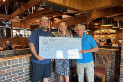 Representative of Vanderbilt, Ms. Jenny Streams, accepting the check from the two most recent past presidents, Mr. Chris Lanier and Mr. Jim Crisafulli