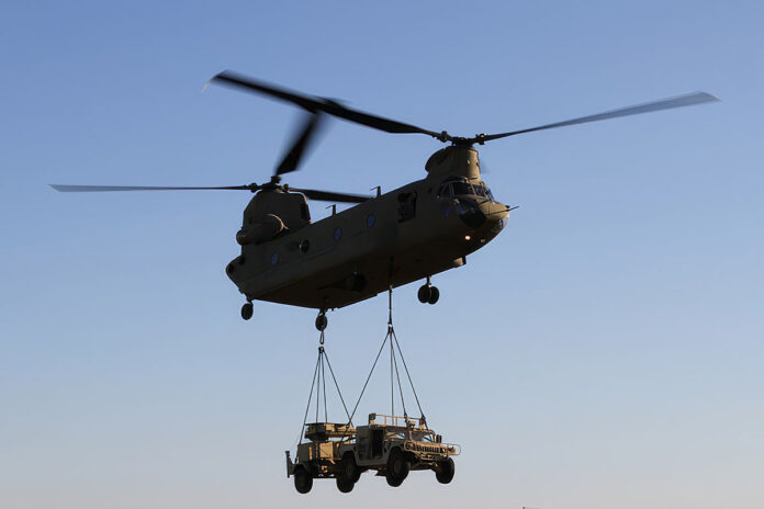 A CH-47 Chinook helicopters from Company B, 6th Battalion, 101st Combat Aviation Brigade, 101st Airborne Division (Air Assault), lifts a Humvee and a AN/MPQ-64A Sentinel radar during a training mission. (U.S. Army Photo by Sgt. Leejay Lockhart, 101st Sustainment Brigade Public Affairs)