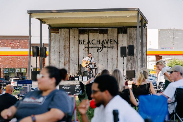 Visitors and residents alike enjoy live music on the lawn at Beachaven Winery. (Cultivated Co.)