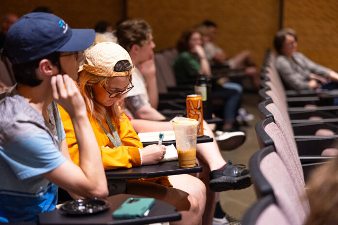 Students listen and take notes during a reading by author Joe Milan Jr. hosted at Austin Peay State University. (Sean McCully, APSU)