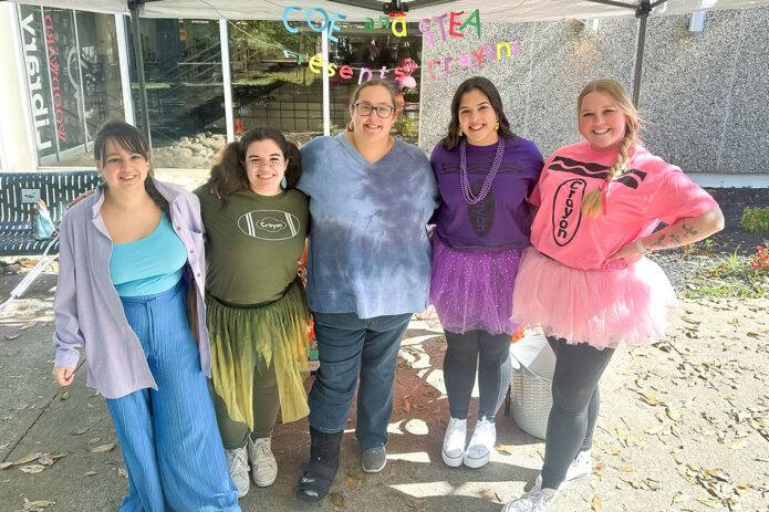 Sarah Earls (center), poses with other STEA officers and members while representing the student organization at Austin Peay State University’s annual G.H.O.S.T. community trick-or-treating event in October 2024. (Photo provided)