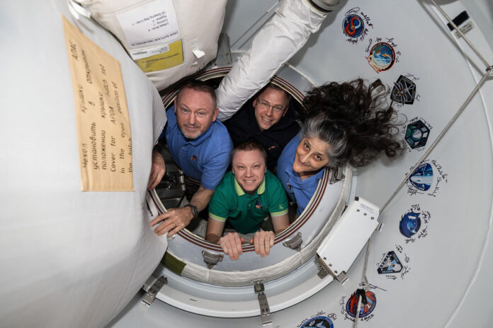 NASA’s SpaceX Crew-9 members pose together for a portrait inside the vestibule between the International Space Station and the SpaceX Dragon crew spacecraft. Clockwise from left, are NASA astronauts Butch Wimore, Nick Hague, and Suni Williams, and Roscosmos cosmonaut Aleksandr Gorbunov. (NASA)