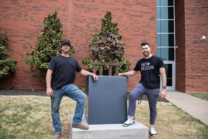Araan Schmidt, at left, is the artist behind “Cracked Earth,” APSU’s first outdoor public sculpture since 2018. Also pictured is Luke Warren, Austin Peay State University assistant professor of sculpture, who facilitated the installation. (Herzel Sireci, APSU)