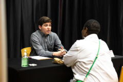 Sebastian Galarza-Grillasca, a senior computer information systems major, meets with a potential employer during Austin Peay State University’s Reverse Career Fair. His goal is to combat phishing scams and other forms of cybercrime. (Sean McCully, APSU)