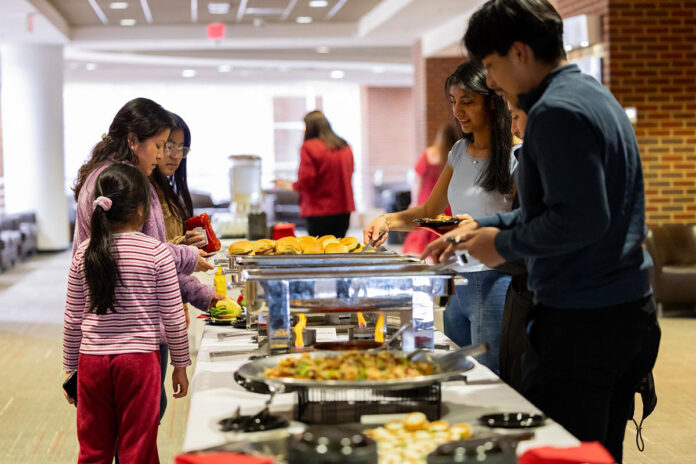 First-generation college students and their families enjoy a buffet during the spring induction ceremony for Austin Peay State University’s Tri-Alpha Honor Society chapter. (Sean McCully, APSU)