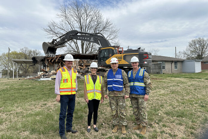 Fort Campbell Garrison Commander Col. Chris Midberry prepares to use an excavator to begin the demolition of a family home in Hammond Heights. The demolition is part of a bigger project to renovate the entire Hammond Heights housing community. (Jedhel Somera, Fort Campbell Public Affairs Office)