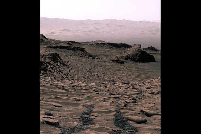 NASA’s Curiosity Mars rover sees its tracks receding into the distance at a site nicknamed “Ubajara” on April 30, 2023. This site is where Curiosity made the discovery of siderite, a mineral that may help explain the fate of the planet’s thicker ancient atmosphere. (NASA/JPL-Caltech/MSSS)