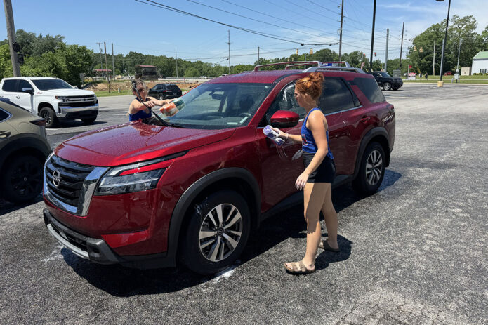Montgomery Central High School Cheerleaders getting cars clean at their Car Wash fundraiser at Hilltop Supermarket. (Mark Haynes, Clarksville Online)
