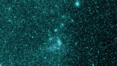 This image from NASA’s SPHEREx shows the same region of space in a different infrared wavelength (0.98 microns), but the dust cloud is no longer visible. The molecules that compose the dust — polycyclic aromatic hydrocarbons — do not radiate light in this color. (NASA/JPL-Caltech)