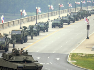 U.S. Army Soldiers, heavy equipment including M1A2 Abrams tanks, and light vehicles including light medium tactical vehicles merge as they prepare to march in the 250th Army Birthday Parade June 14, 2025, in Washington, D.C. The national level celebration included a day-long festival at the National Mall in Washington, D.C., a parade and a spectacular fireworks display. (U.S. Army photo by Sgt. 1st Class Rakeem Carter)