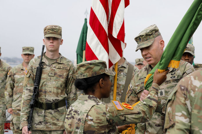 U.S. Army Lt. Col. Nicole M. Griffith, incoming commander of the 716th Military Police Battalion, under Joint Task Force-Southern Border, gives the unit’s guidon to Command Sgt. Maj. David J. Parthemore, the battalion’s command sergeant major, during the change of command ceremony at San Diego, CA, June 16th, 2025. (U.S. Army photo by Staff Sgt. Christopher Neu)