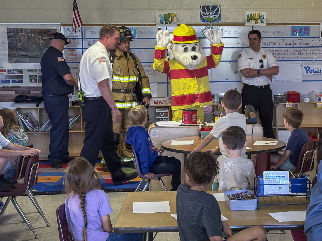 Firefighters spoke with students about the importance of fire safety, the need for a family emergency plan, and how to stay calm and safe during an emergency. They also gave students a close-up look at their gear, tools, and fire trucks, explaining how each piece of equipment helps them protect the community. (Justin Moeller, Blanchfield Army Community Hospital)