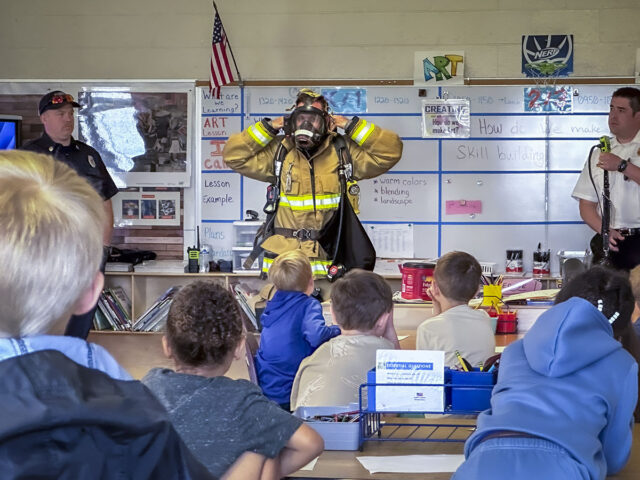Firefighters spoke with students about the importance of fire safety, the need for a family emergency plan, and how to stay calm and safe during an emergency. They also gave students a close-up look at their gear, tools, and fire trucks, explaining how each piece of equipment helps them protect the community. (Justin Moeller, Blanchfield Army Community Hospital)