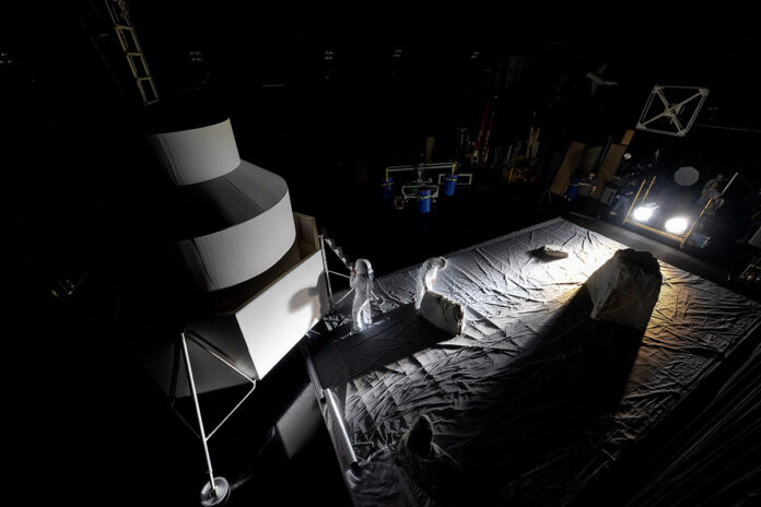 NASA engineers inside the Flat Floor Facility at Marshall Space Flight Center in Huntsville, Alabama, mimic lander inspection and assessment tasks future Artemis astronauts may do during Artemis III. Lights are positioned at a low angle to replicate the strong shadows that are cast across the lunar South Pole. (NASA/Charles Beason)