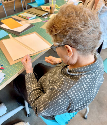 Participant Ann Silverberg binding her journal