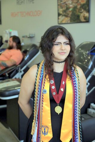 RHS Graduate Toni Munoz shows off her Cord of Courage, along with other cords and pins she earned during her high school career. (Tony Centonze, Clarksville Living Magazine)
