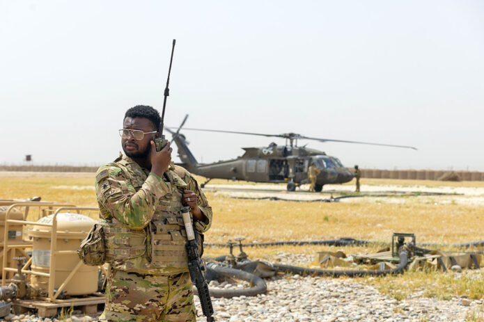 Staff Sgt. Gianni Dunlap, a U.S. Army Air Traffic Controller assigned to Task Force Nighthawk, 101st Airborne Division (Air Assault) makes calls to a UH-60 Black Hawk Helicopter, May 1st, 2025, at Rumalyn Landing Zone, Syria. Controllers provide real-time airspace deconfliction and landing clearance to ensure safe rotary-wing operations within controlled airspace. (Capt. Andrew Lightsey IV, 101st Combat Aviation Brigade) 