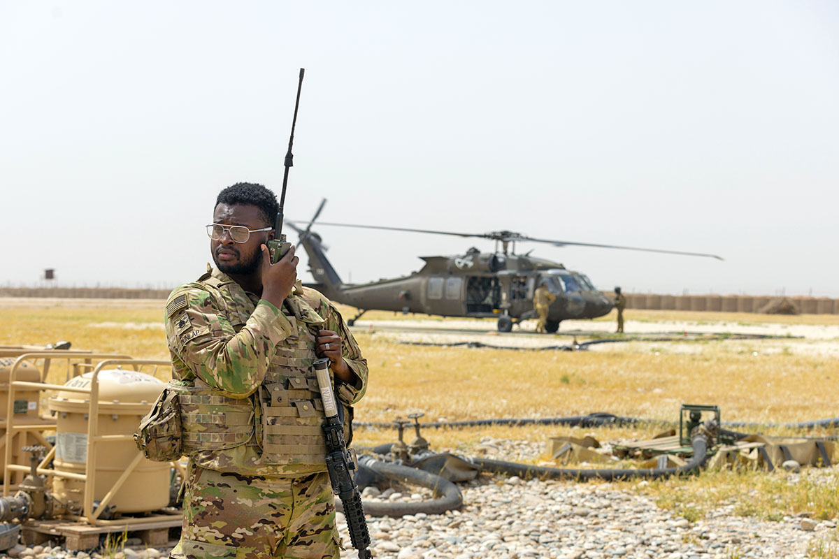 Staff Sgt. Gianni Dunlap, a U.S. Army Air Traffic Controller assigned to Task Force Nighthawk, 101st Airborne Division (Air Assault) makes calls to a UH-60 Black Hawk Helicopter, May 1st, 2025, at Rumalyn Landing Zone, Syria. Controllers provide real-time airspace deconfliction and landing clearance to ensure safe rotary-wing operations within controlled airspace. (Capt. Andrew Lightsey IV, 101st Combat Aviation Brigade)