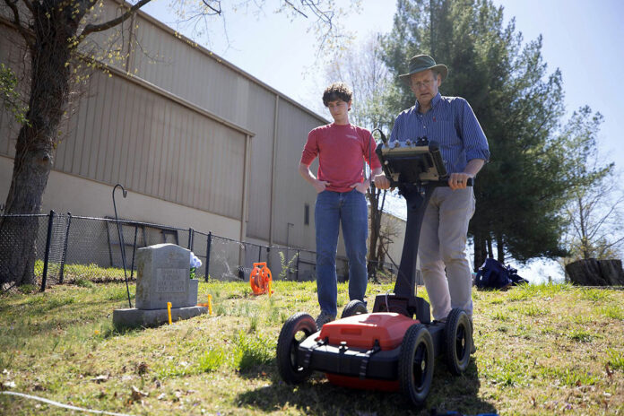 Dr. Daniel Frederick, a professor in Austin Peay State University’s Department of Earth and Environmental Sciences, operates a Ground Penetrating Radar (GPR) at Riverview Cemetery to assist with health and human performance major Patrick Richardson’s research project on cemetery waste. (APSU