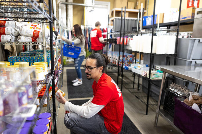 Volunteers work to stock the S.O.S. Food Pantry at Austin Peay State University with supplemental food items for students. (Madison Casey, APSU)