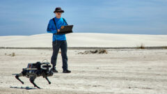 A researcher monitors LASSIE-M (Legged Autonomous Surface Science In Analogue Environments for Mars), a robot being developed by NASA’s Johnson Space Center and other institutions, during testing this year at New Mexico’s White Sands National Park. (Justin Durner)