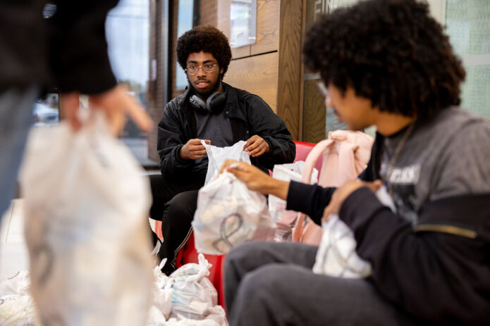 Kameron and other first-year students participate in a community service project with FUEL for Kids, packing 200 meal bags for local children. (Sean McCully, APSU)