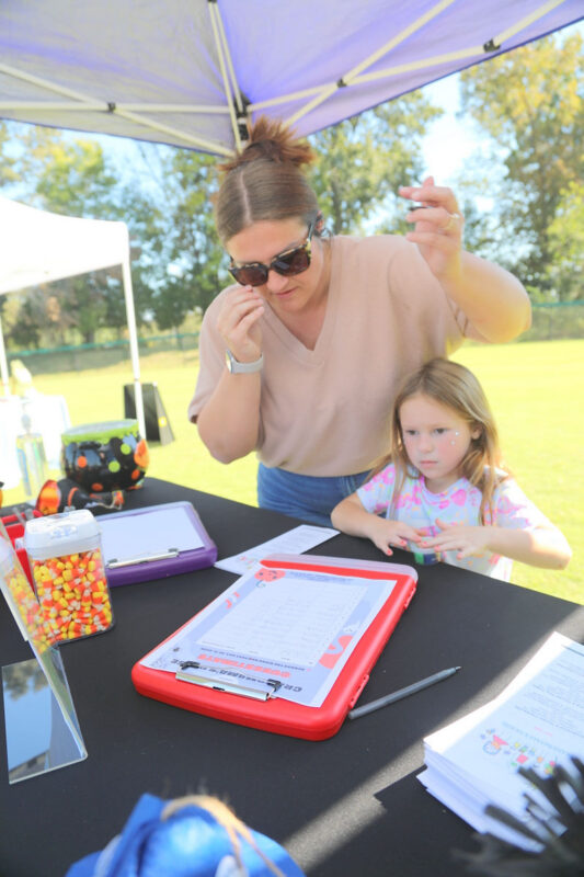 Breinna and Eloise West guessing the number of candycorns for a chance to win gift cards from Grandmama&rsquo;s House of Preschool