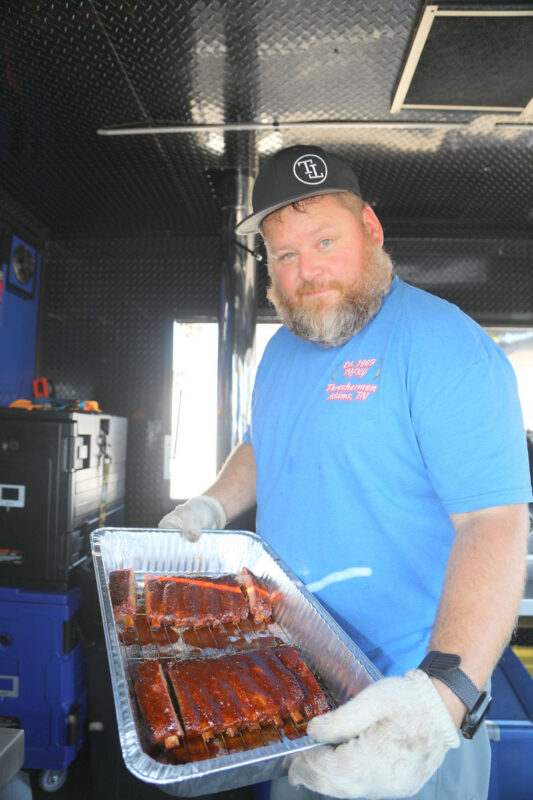 Chris Eckard of the Big James&rsquo; Kitchen team holding the ribs they entered for the inaugural BBQ Fest Across the River competition at RichEllen Park